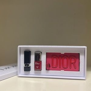 Dior box with a travel tag and rouge lip stick and nail polish